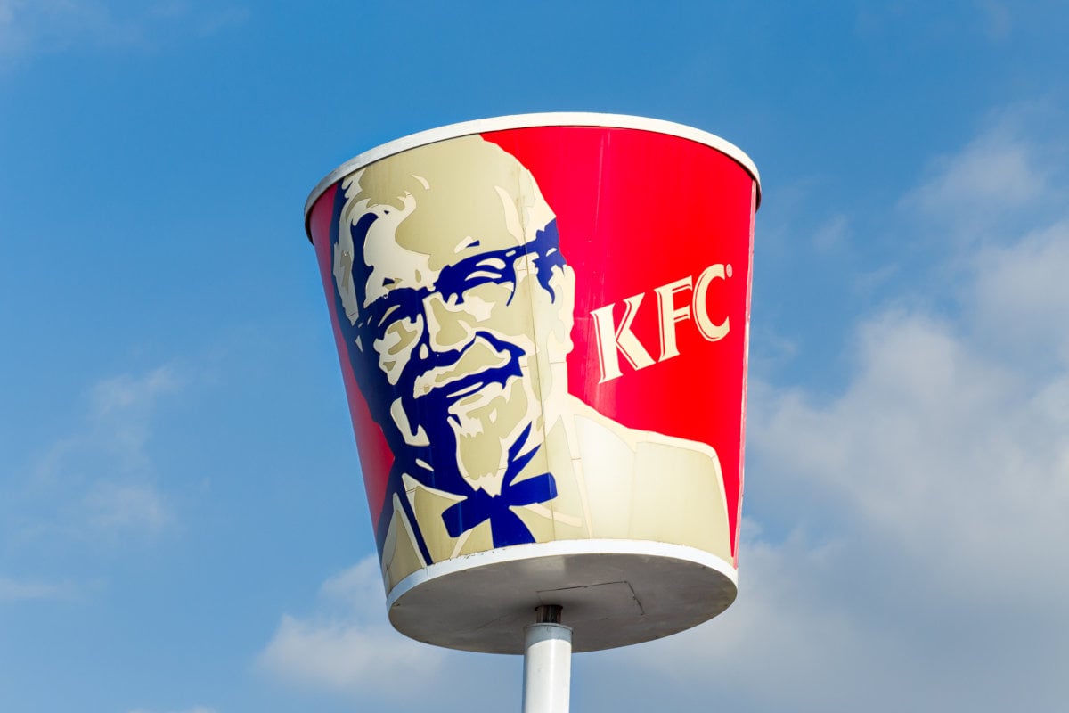 KFC’s Menu Innovations; KFC chicken bucket on a pillar outside of a store on a clear day.