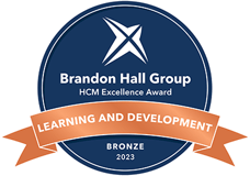 Navy blue circular training program award logo reads: Brandon Hall Award for Best Results in a Learning Program. Bronze 2023